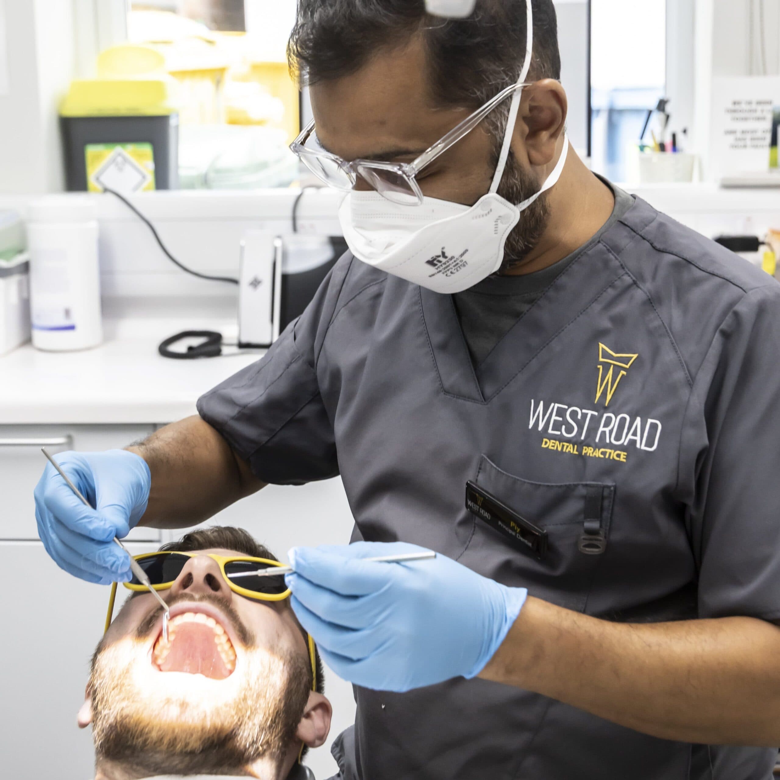 A West Road Dental dentist treating a patient reclined in the chair