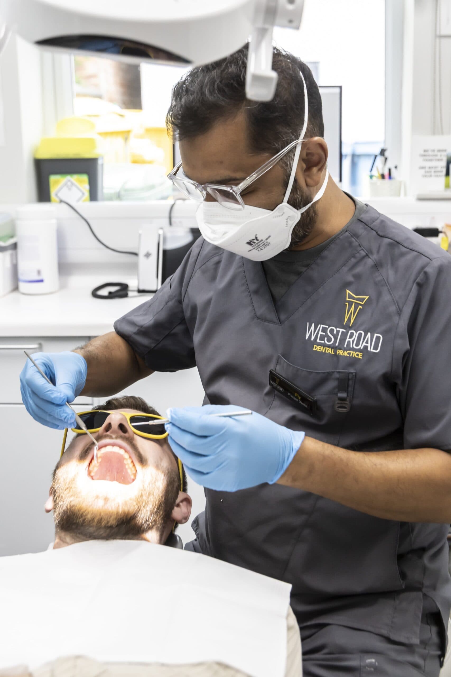 A dentist at West Road Dental Practice carrying out treatment on a patient